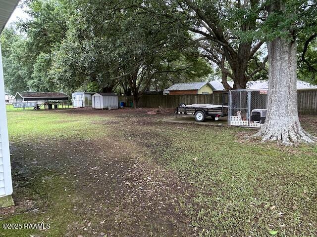 143 Monette St, Ville Platte, LA 70586 - view of yard featuring a storage shed, fence, and an outbuilding