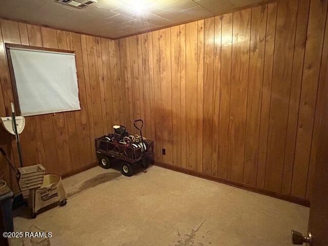 143 Monette St, Ville Platte, LA 70586 - carpeted spare room with wood walls and baseboards