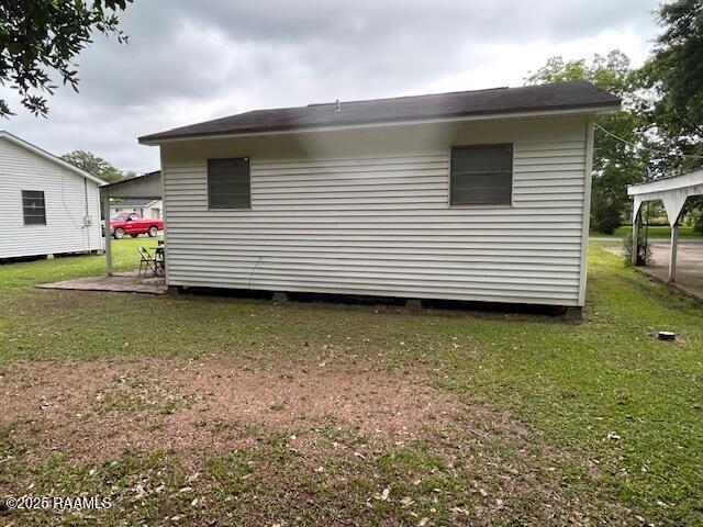 143 Monette St, Ville Platte, LA 70586 - view of home's exterior with a lawn