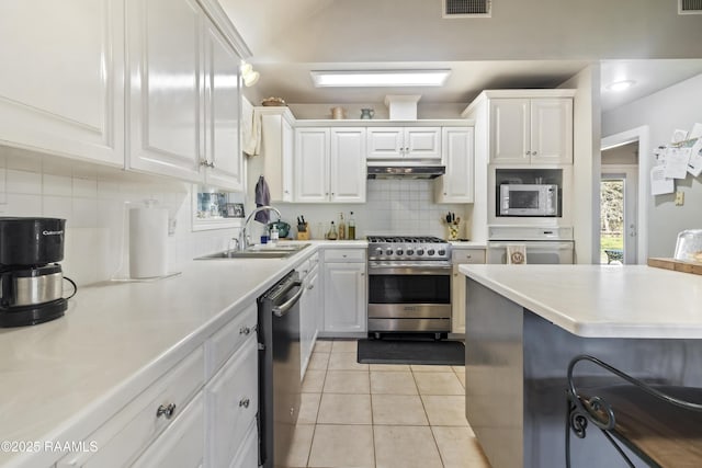 10154 Willow Crest Rd, Abbeville, LA 70510 - kitchen featuring stainless steel appliances, a sink, white cabinetry, and tasteful backsplash