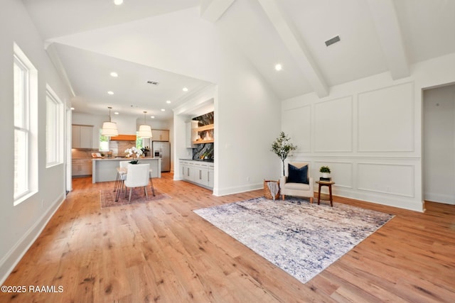 108 Meadowbrook Dr, Broussard, LA 70518 - sitting room with light wood-style floors, beam ceiling, recessed lighting, a decorative wall, and baseboards