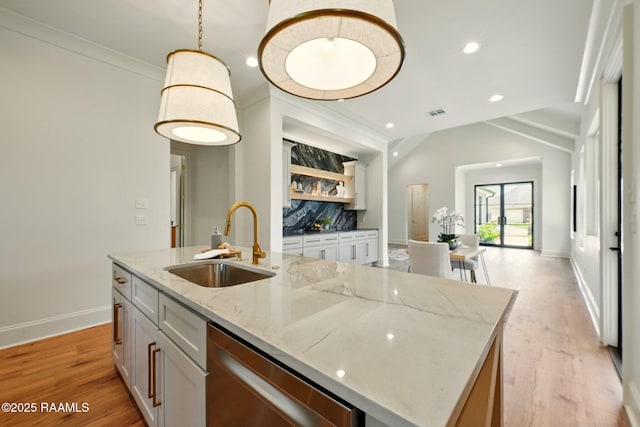 108 Meadowbrook Dr, Broussard, LA 70518 - kitchen with a sink, stainless steel dishwasher, baseboards, light stone counters, and light wood-style flooring