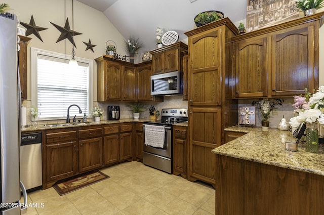 100 Mirada Ln, Lafayette, LA 70508 - kitchen featuring stainless steel appliances, a sink, tasteful backsplash, light stone countertops, and high vaulted ceiling