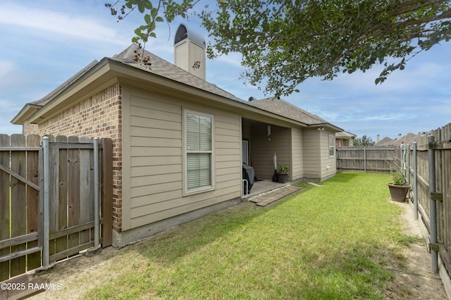 100 Mirada Ln, Lafayette, LA 70508 - back of property featuring brick siding, a shingled roof, and a chimney
