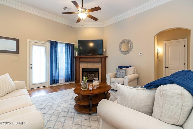 100 Mirada Ln, Lafayette, LA 70508 - living room with a ceiling fan, wood finished floors, ornamental molding, a fireplace, and arched walkways