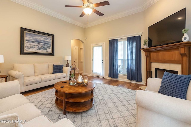100 Mirada Ln, Lafayette, LA 70508 - living area with arched walkways, wood finished floors, a ceiling fan, crown molding, and baseboards