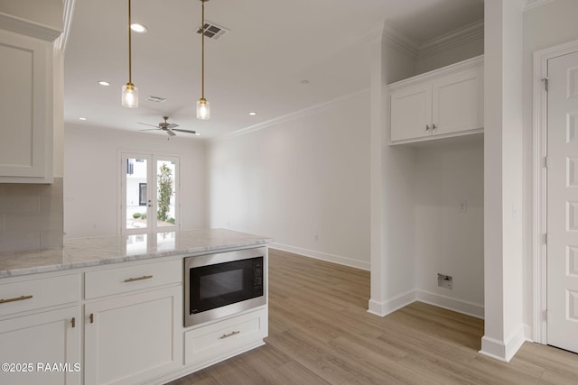 1510 Kaliste Saloom Unit 101, Lafayette, LA 70508 - kitchen with built in microwave, ornamental molding, a peninsula, ceiling fan, and white cabinetry