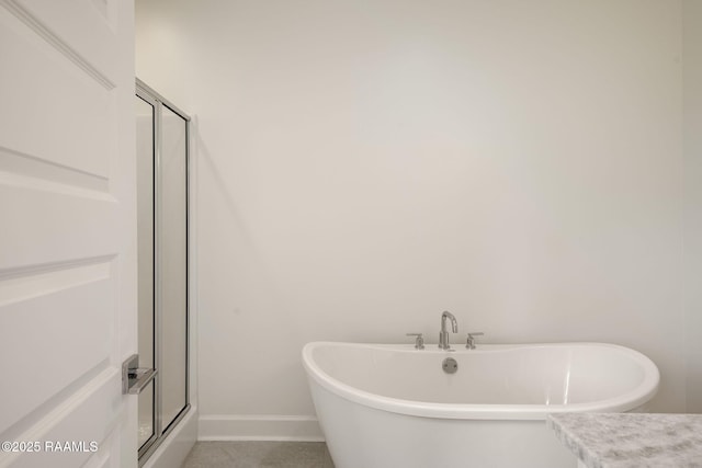 1510 Kaliste Saloom Unit 101, Lafayette, LA 70508 - full bath featuring a freestanding bath, an enclosed shower, and baseboards