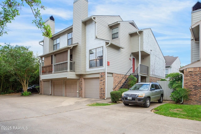 1304 E Bayou Pkwy Unit 4A, Lafayette, LA 70508 - townhome / multi-family property with a chimney, a garage, driveway, and brick siding
