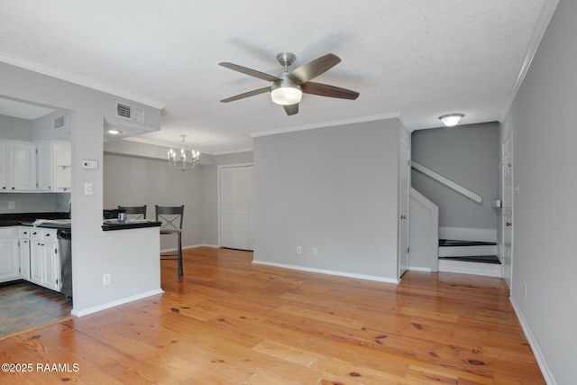 1304 E Bayou Pkwy Unit 4A, Lafayette, LA 70508 - unfurnished living room featuring ceiling fan, crown molding, light wood-style floors, a chandelier, and baseboards