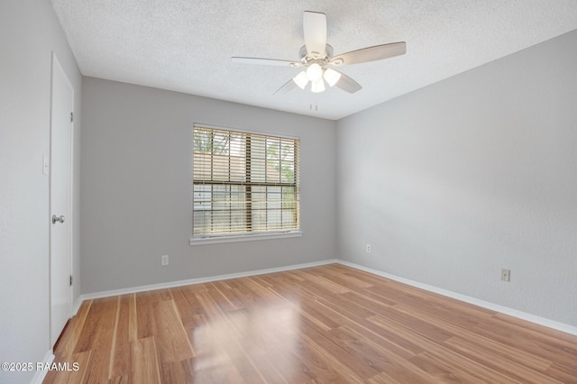 1304 E Bayou Pkwy Unit 4A, Lafayette, LA 70508 - empty room with light wood finished floors, a textured ceiling, a ceiling fan, and baseboards