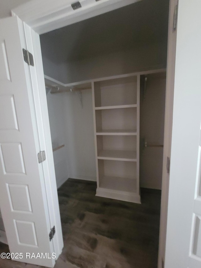 313 Harvest Ln, Abbeville, LA 70510 - spacious closet with dark wood finished floors