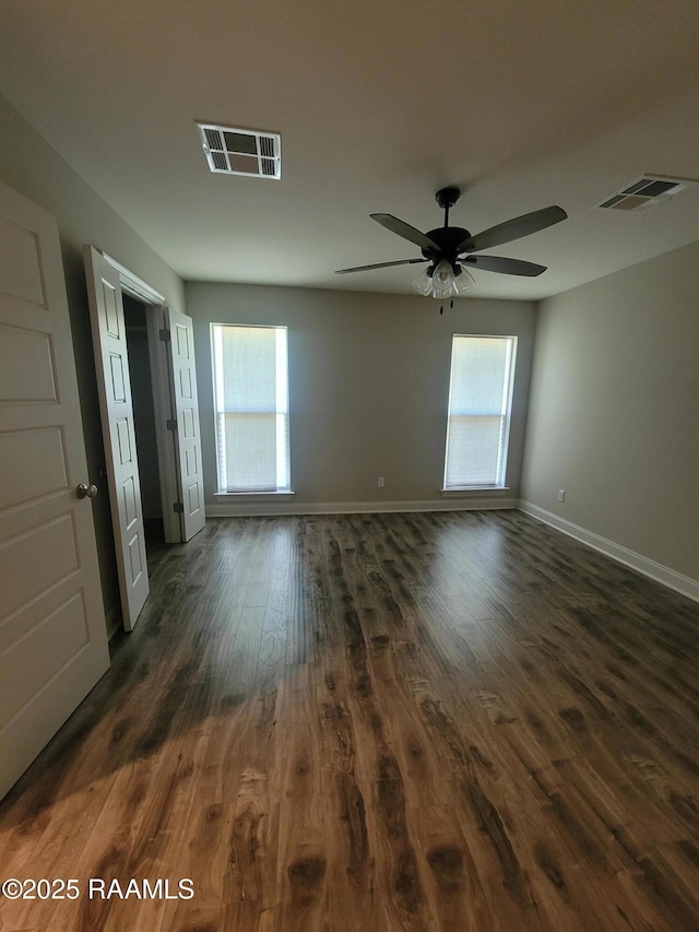 313 Harvest Ln, Abbeville, LA 70510 - unfurnished room featuring dark wood-type flooring, plenty of natural light, baseboards, and a ceiling fan