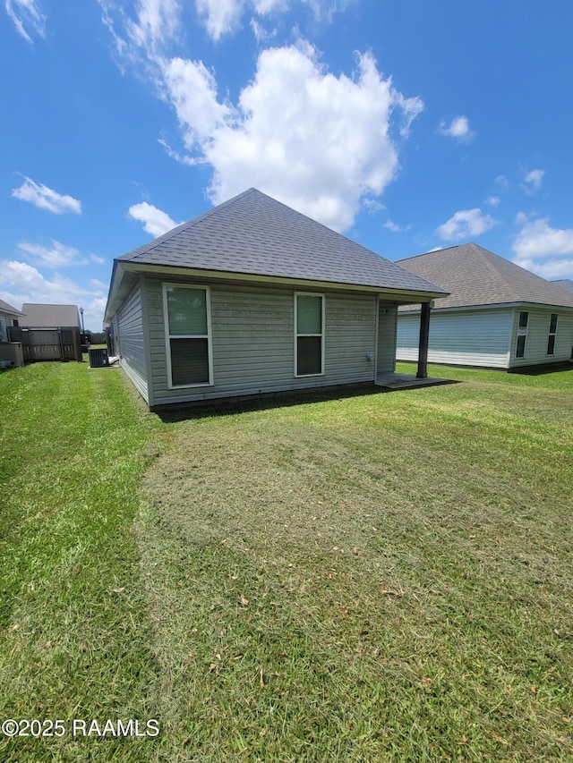 313 Harvest Ln, Abbeville, LA 70510 - rear view of house with roof with shingles and a lawn