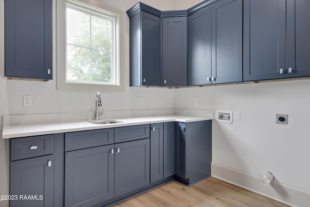 104 Wishing Well Dr, Broussard, LA 70518 - laundry room with hookup for an electric dryer, hookup for a washing machine, light wood-style floors, cabinet space, and baseboards
