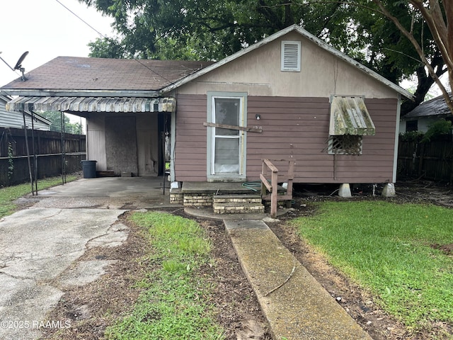 130 Champagne St, Lafayette, LA 70501 - view of front of home with driveway, an attached carport, and roof with shingles