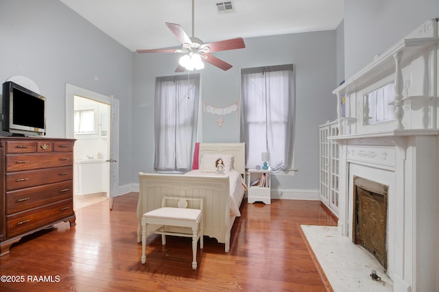 307 N Market St, Opelousas, LA 70570 - bedroom featuring a fireplace with flush hearth, wood finished floors, and baseboards