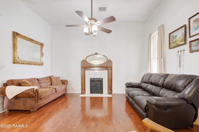307 N Market St, Opelousas, LA 70570 - living area with crown molding, wood finished floors, ceiling fan, baseboards, and a fireplace