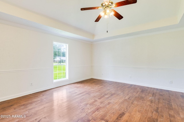 421 Plantation Rd, Opelousas, LA 70570 - empty room with a raised ceiling, hardwood / wood-style flooring, a ceiling fan, baseboards, and ornamental molding