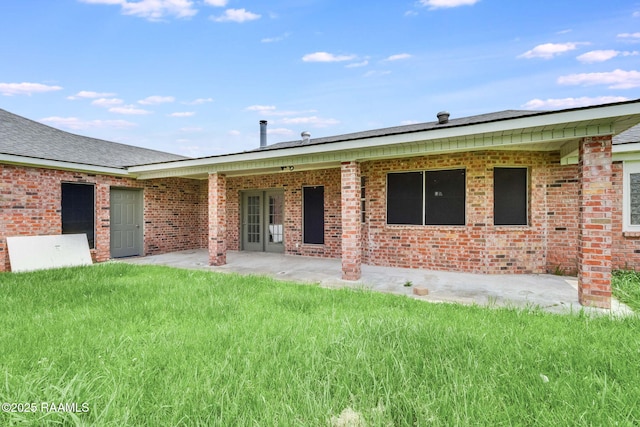 421 Plantation Rd, Opelousas, LA 70570 - back of house with a patio area, a yard, and brick siding