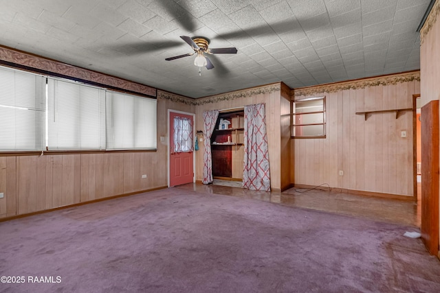 423 E 1st St, Jennings, LA 70546 - empty room featuring a ceiling fan, baseboards, and wooden walls