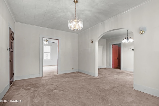 423 E 1st St, Jennings, LA 70546 - empty room featuring a chandelier, ornamental molding, carpet flooring, arched walkways, and baseboards