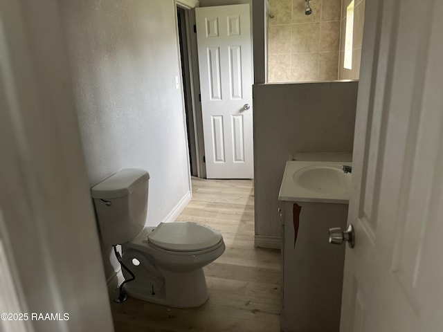 113 Fred St, Lafayette, LA 70501 - bathroom featuring wood finished floors, toilet, vanity, and baseboards