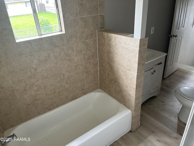 113 Fred St, Lafayette, LA 70501 - full bathroom featuring toilet, wood finished floors, vanity, and a bathtub