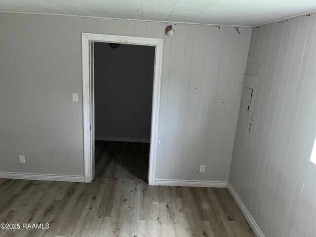 113 Fred St, Lafayette, LA 70501 - empty room with wood finished floors, baseboards, and wood walls