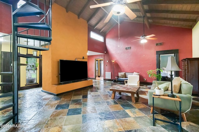 146 Steiner Rd, Lafayette, LA 70508 - living room featuring stone tile flooring, a ceiling fan, wooden ceiling with exposed beams, high vaulted ceiling, and baseboards