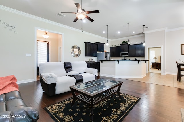 123 Angel Rock Ln, Broussard, LA 70518 - living area with ceiling fan, light wood-type flooring, ornamental molding, plenty of natural light, and baseboards
