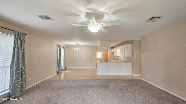 113 Jeanne St, Eunice, LA 70535 - unfurnished living room with ceiling fan, a chandelier, light colored carpet, and baseboards