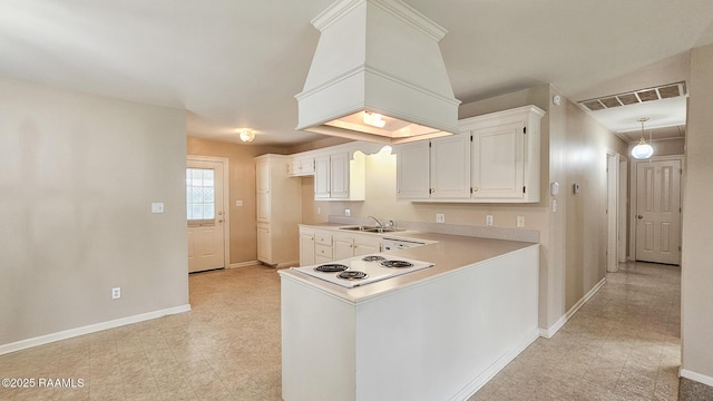 113 Jeanne St, Eunice, LA 70535 - kitchen featuring a sink, baseboards, light countertops, white cabinets, and white cooktop