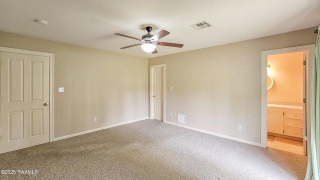 113 Jeanne St, Eunice, LA 70535 - unfurnished bedroom featuring carpet, baseboards, ensuite bathroom, and a ceiling fan