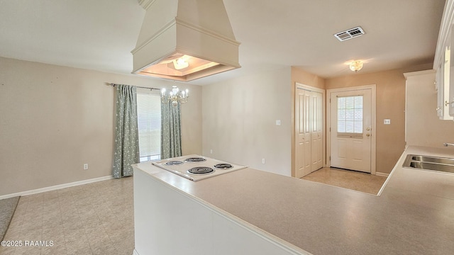 113 Jeanne St, Eunice, LA 70535 - kitchen with a sink, stovetop, baseboards, and a chandelier