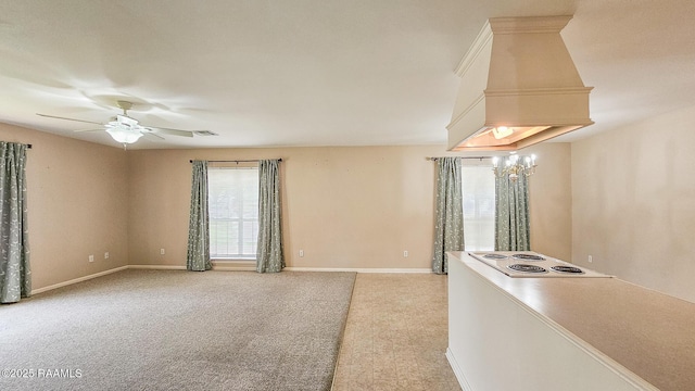 113 Jeanne St, Eunice, LA 70535 - kitchen featuring ceiling fan, light colored carpet, cooktop, and baseboards