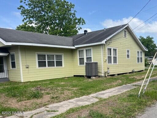201 Allen St, New Iberia, LA 70563 - back of house with central air condition unit and a lawn