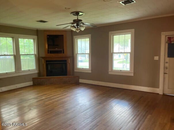 201 Allen St, New Iberia, LA 70563 - unfurnished living room featuring ornamental molding, baseboards, a fireplace with raised hearth, ceiling fan, and wood finished floors