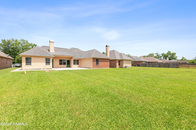 1117 Jules Broussard Rd, Breaux Bridge, LA 70517 - rear view of property featuring a patio and a chimney