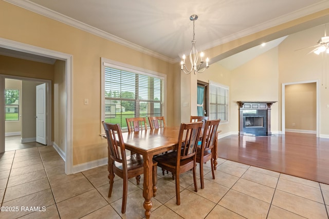 1117 Jules Broussard Rd, Breaux Bridge, LA 70517 - dining room with light tile patterned flooring, a chandelier, vaulted ceiling, a fireplace, and baseboards