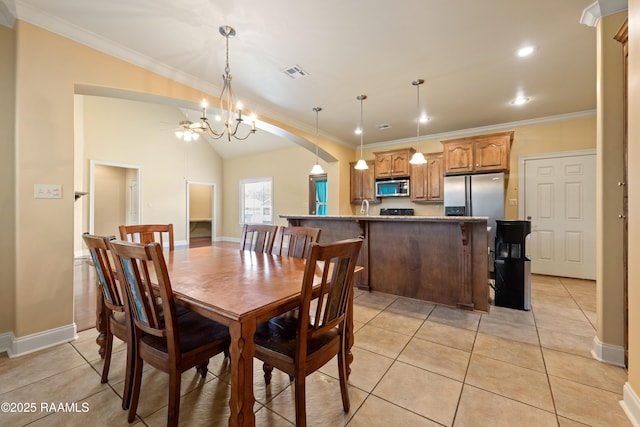 1117 Jules Broussard Rd, Breaux Bridge, LA 70517 - dining space featuring crown molding, arched walkways, light tile patterned flooring, a chandelier, and baseboards