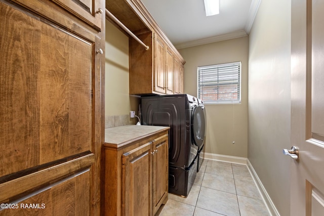 1117 Jules Broussard Rd, Breaux Bridge, LA 70517 - laundry room with washing machine and dryer, cabinet space, light tile patterned flooring, crown molding, and baseboards