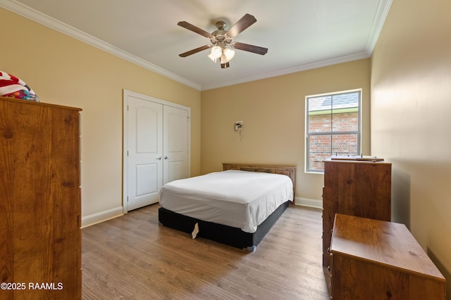 1117 Jules Broussard Rd, Breaux Bridge, LA 70517 - bedroom featuring wood finished floors, ornamental molding, baseboards, a closet, and a ceiling fan