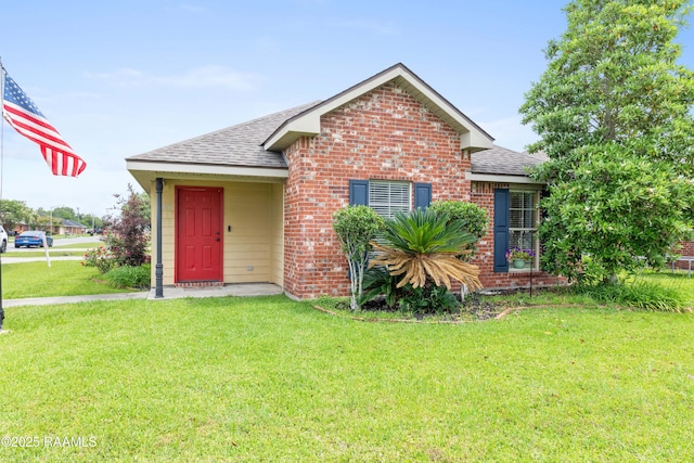 320 Golden Grain, Duson, LA 70529 - view of front facade with roof with shingles, a front yard, and brick siding