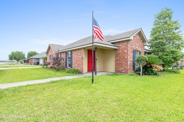 320 Golden Grain, Duson, LA 70529 - view of front facade featuring a front yard, brick siding, and roof with shingles