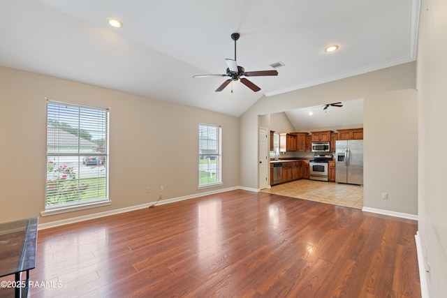 320 Golden Grain, Duson, LA 70529 - unfurnished living room with a ceiling fan, healthy amount of natural light, lofted ceiling, light wood finished floors, and baseboards