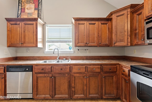 320 Golden Grain, Duson, LA 70529 - kitchen featuring stainless steel appliances, a sink, lofted ceiling, and brown cabinets