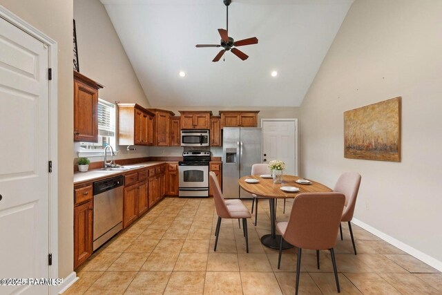 320 Golden Grain, Duson, LA 70529 - kitchen with appliances with stainless steel finishes, high vaulted ceiling, a sink, a ceiling fan, and brown cabinetry