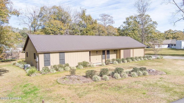 115 Hiawatha Rd, Lafayette, LA 70501 - view of front of property with central air condition unit, a front lawn, and metal roof