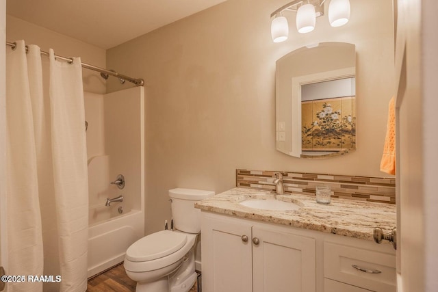 115 Hiawatha Rd, Lafayette, LA 70501 - full bathroom featuring toilet, vanity, shower / bath combo with shower curtain, wood finished floors, and tasteful backsplash